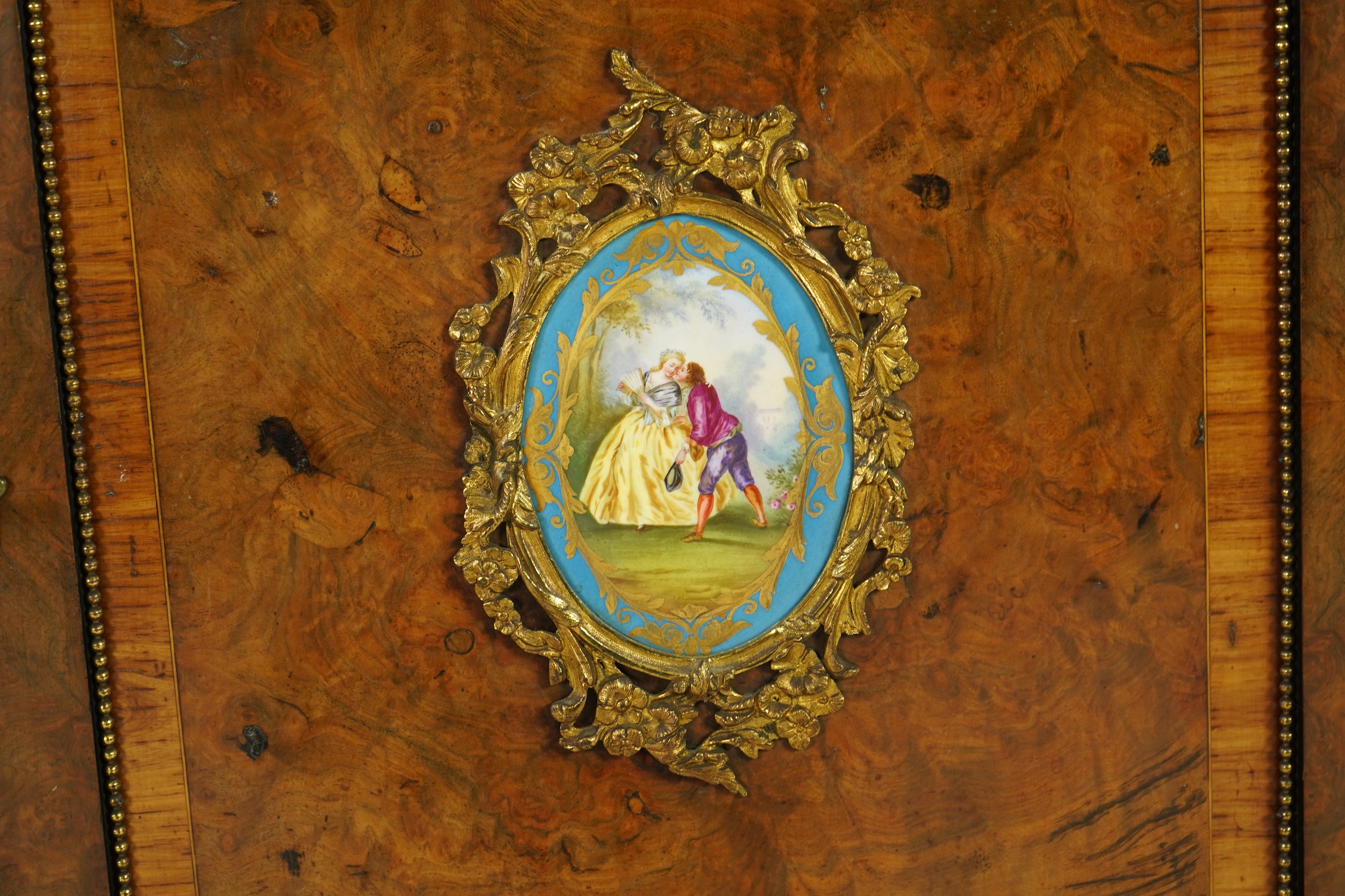 A Victorian tulip banded and gilt metal mounted walnut breakfront side cabinet